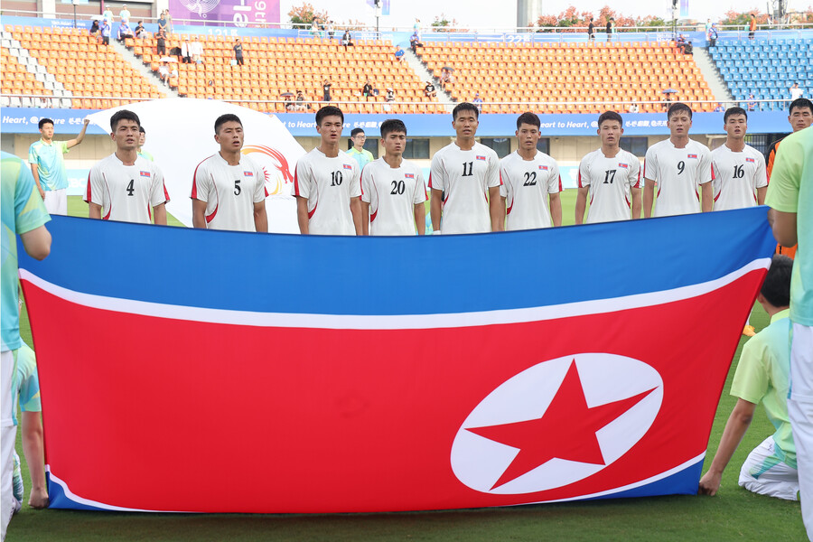 ▲ 19일 중국 항저우 진화 저장 사범대학교 경기장에서 열린 2022 항저우 아시안게임 남자축구 조별리그 F조 1차전 대만과 경기를 앞두고 국가를 부르는 북한 선수단. ⓒ연합뉴스